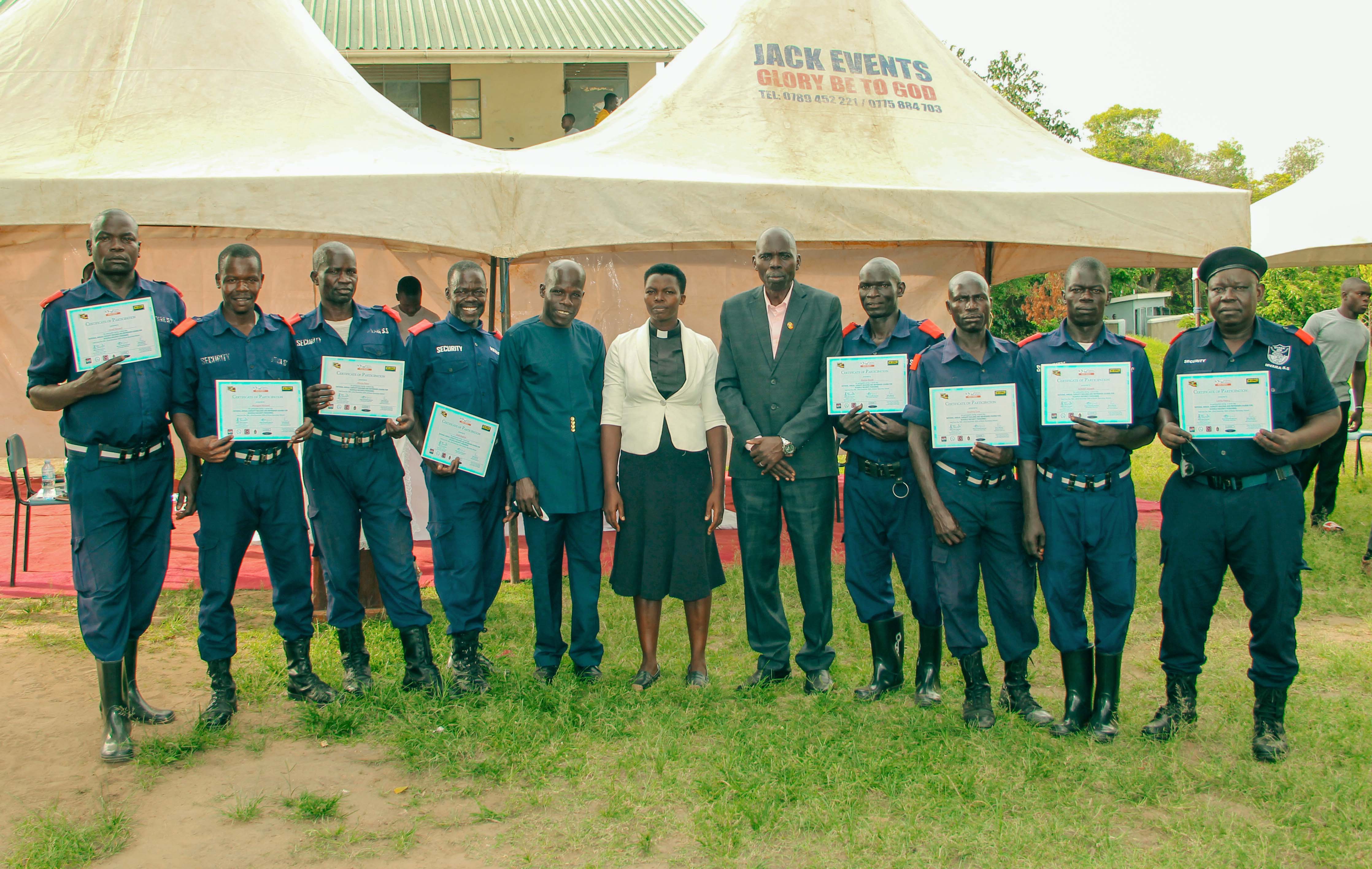 Head Teacher, Chaplain and the Security department members pose for a photo after receiving certificates