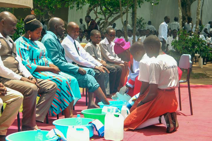 Bishop Rt Rev Collins Andaku washing the feet of Head Teacher and other worshippers on Maundy Thursday in April 2026.