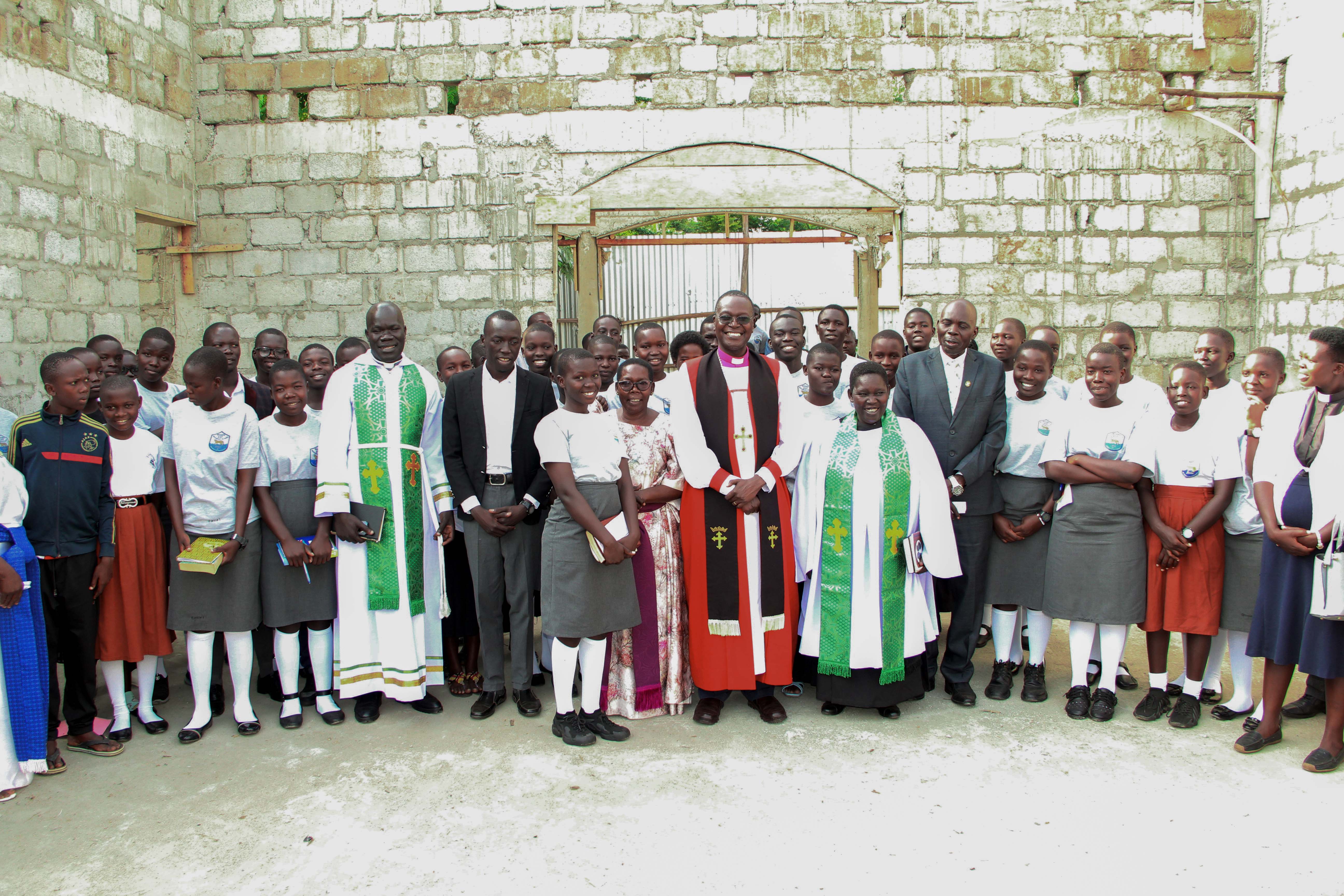 Bishop of Northern Uganda Rt Rev. Godfrey Luwum visits Margaret Lloyd Memorial Chapel construction site and offers prayers.